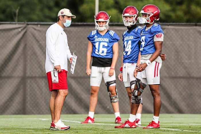 Indiana offensive coordinator Nick Sheridan (left) chats with his quarterbacks during a recent practice. (Photo courtesy IU Athletics)